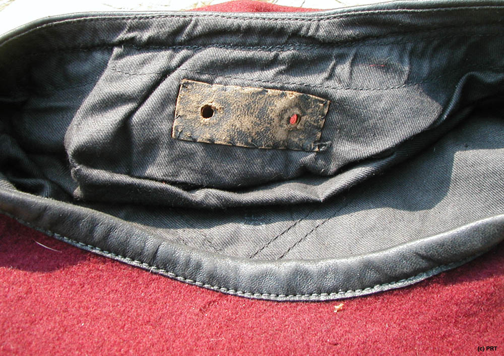 The two holes are covered with a rectangular bit of black leather